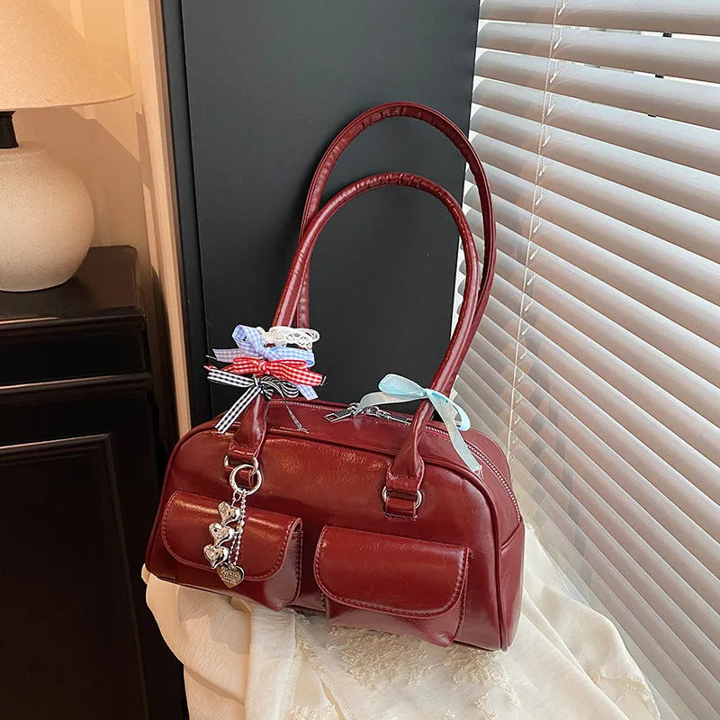 Retro style women's PU leather pillow-shaped flap handbag in black, shown with a double shoulder strap.