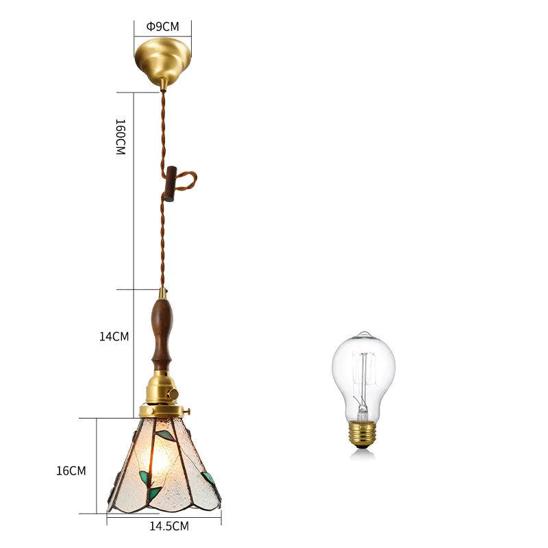 Retro brass and glass chandelier with hand-blown shades hanging on a braided hemp rope light line.