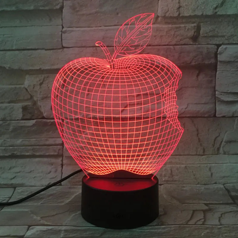 3D acrylic fruit-shaped night light with touch control and multi-colour LED illumination on a dark surface.