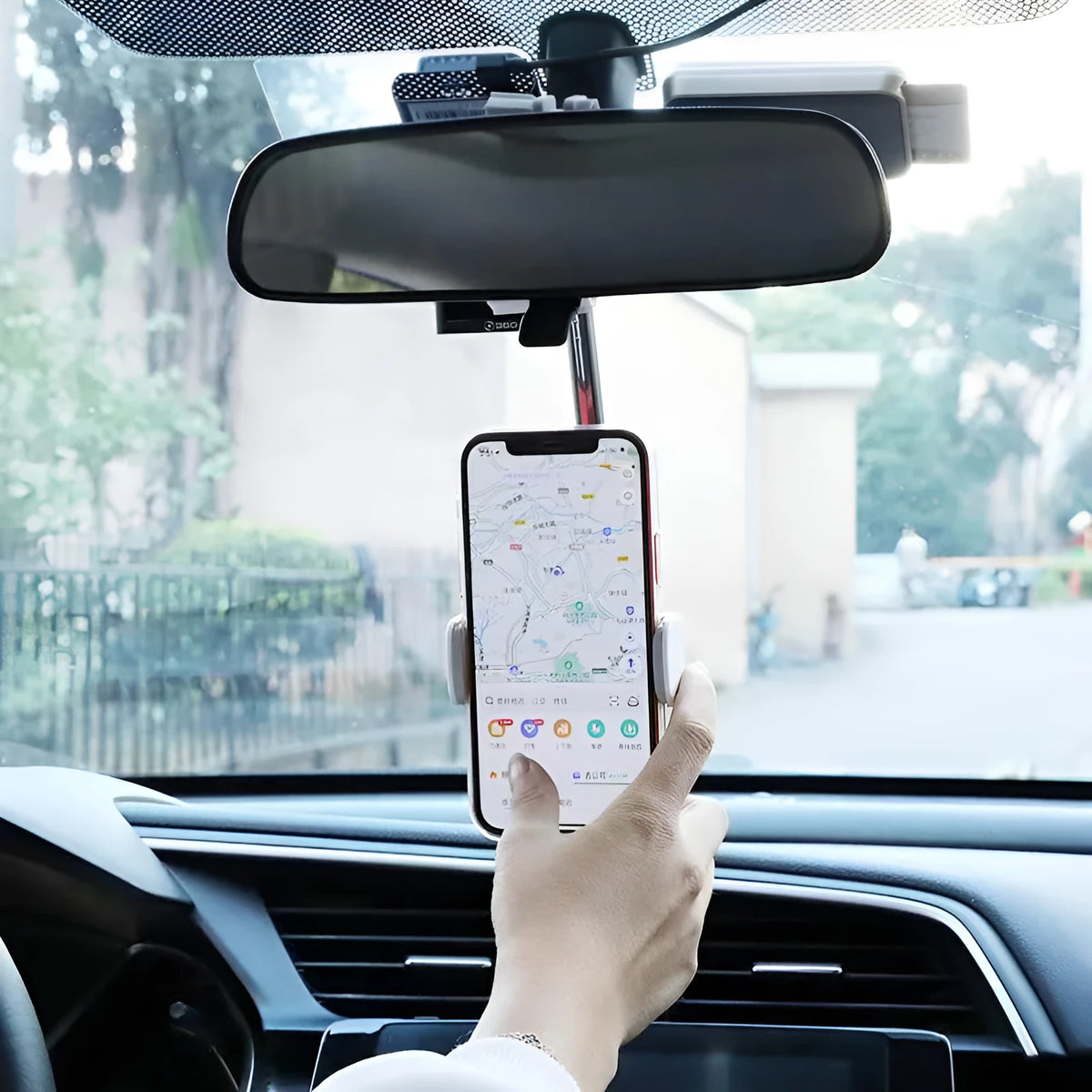 Black ABS mobile phone bracket attached to car rearview mirror holding smartphone