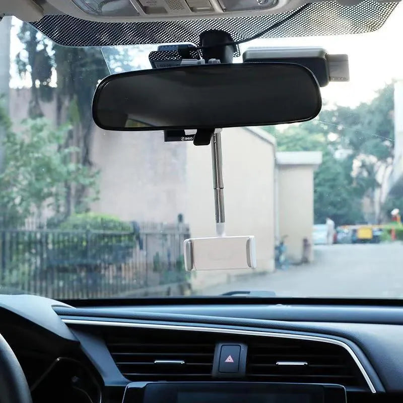 Black ABS mobile phone bracket attached to car rearview mirror holding smartphone