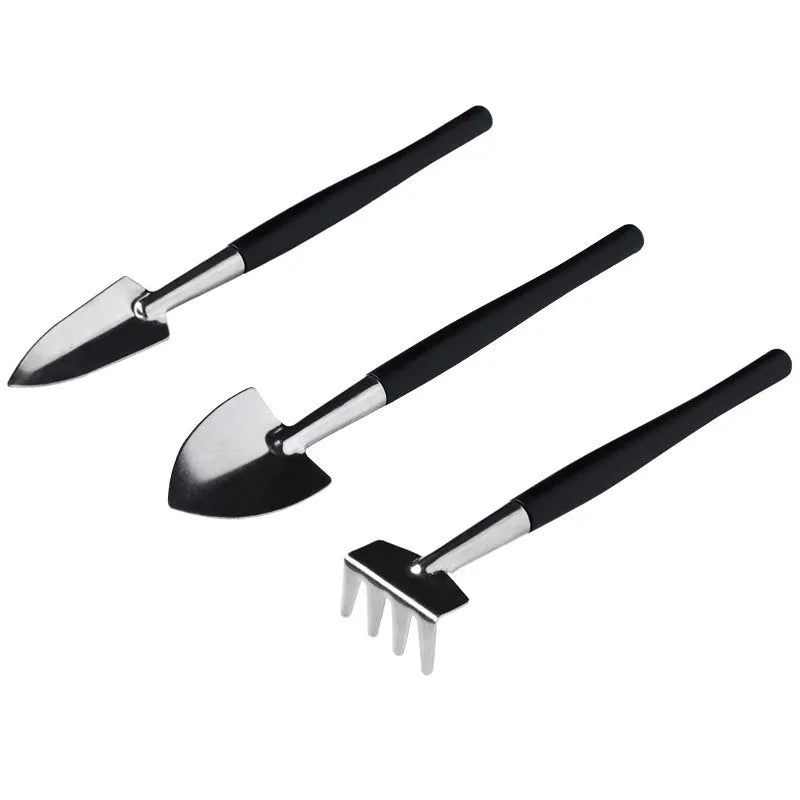 Succulent gardening tools set with mini shovel, tweezers, scissors, watering bottle, and cushion on a table.