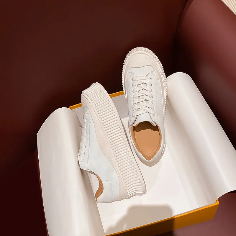 Women's black and white suede platform sneakers with back lacing and a thick sole for height increase.