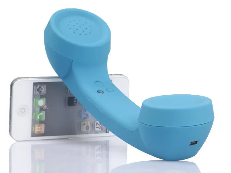 Retro phone style Bluetooth wireless headset in multiple colour options on a table.