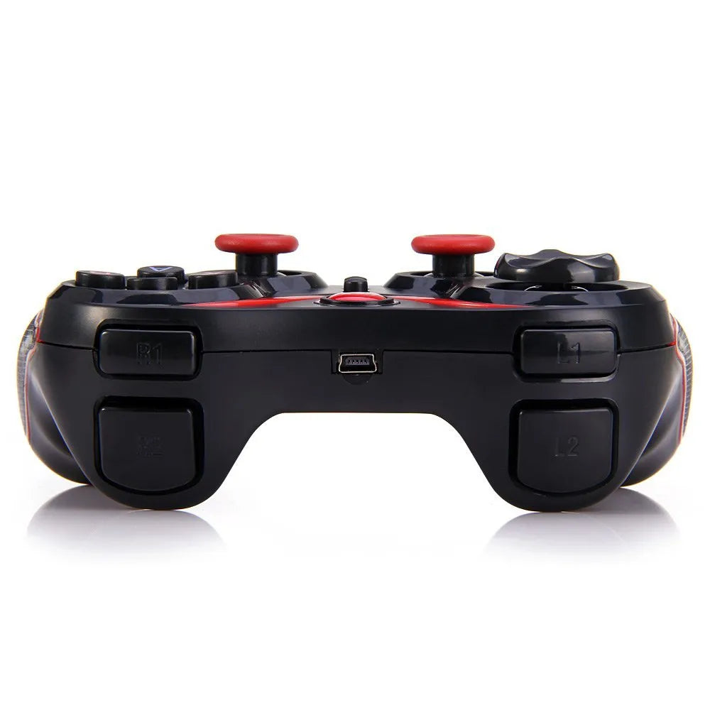 Black wireless Bluetooth gamepad for mobile phones on a table next to a charging cable.