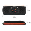 Orange plastic Bluetooth hands-free car kit mounted on a sun visor
