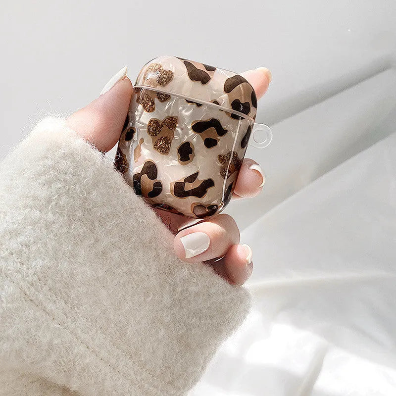 Shell yellow leopard print soft TPU flip case for Apple AirPods Pro on a table.