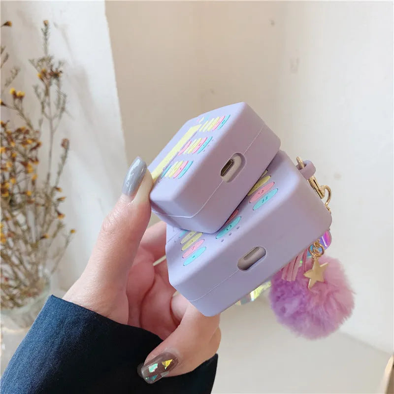 Purple silicone protective case for Apple AirPods wireless headphones with attached fur ball pendant accessory