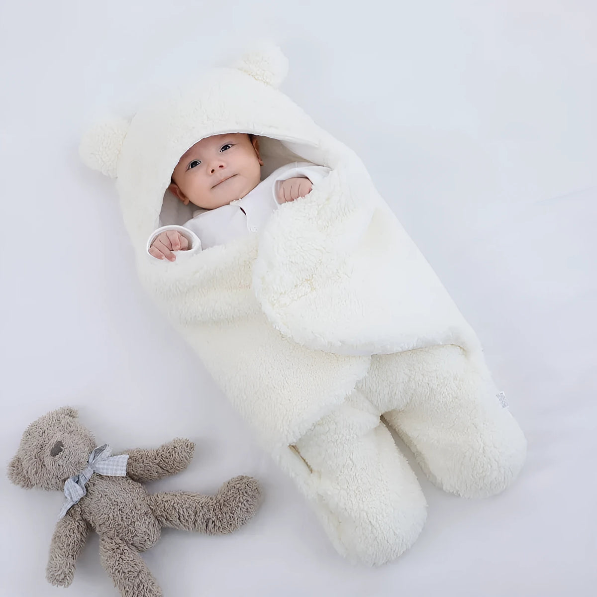 A baby quilted sleeping bag wrapper in a cotton blend fabric, shown in a light blue colour, laid flat.