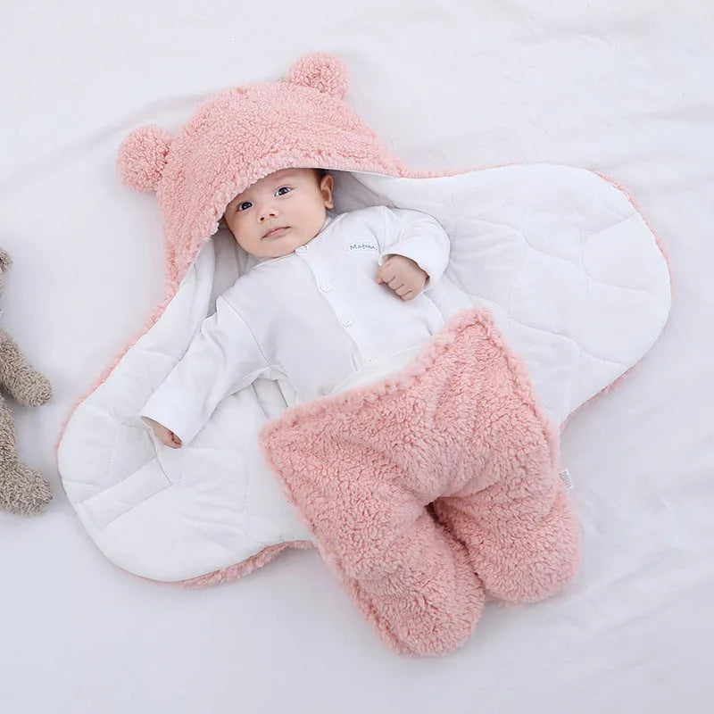 A baby quilted sleeping bag wrapper in a cotton blend fabric, shown in a light blue colour, laid flat.
