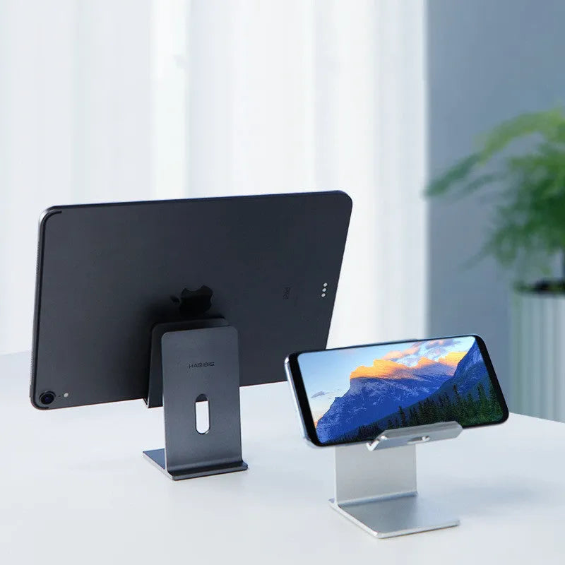 Alloy universal mobile phone holder stand in dark grey or silver on a desktop