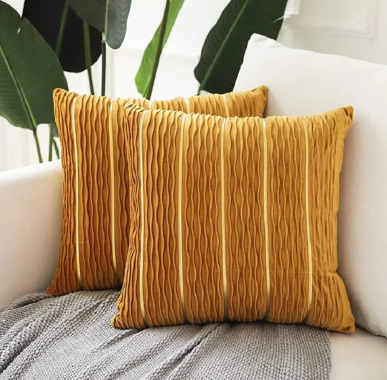 Square 45cm plush velvet pillow cover in wine red colour on a sofa.
