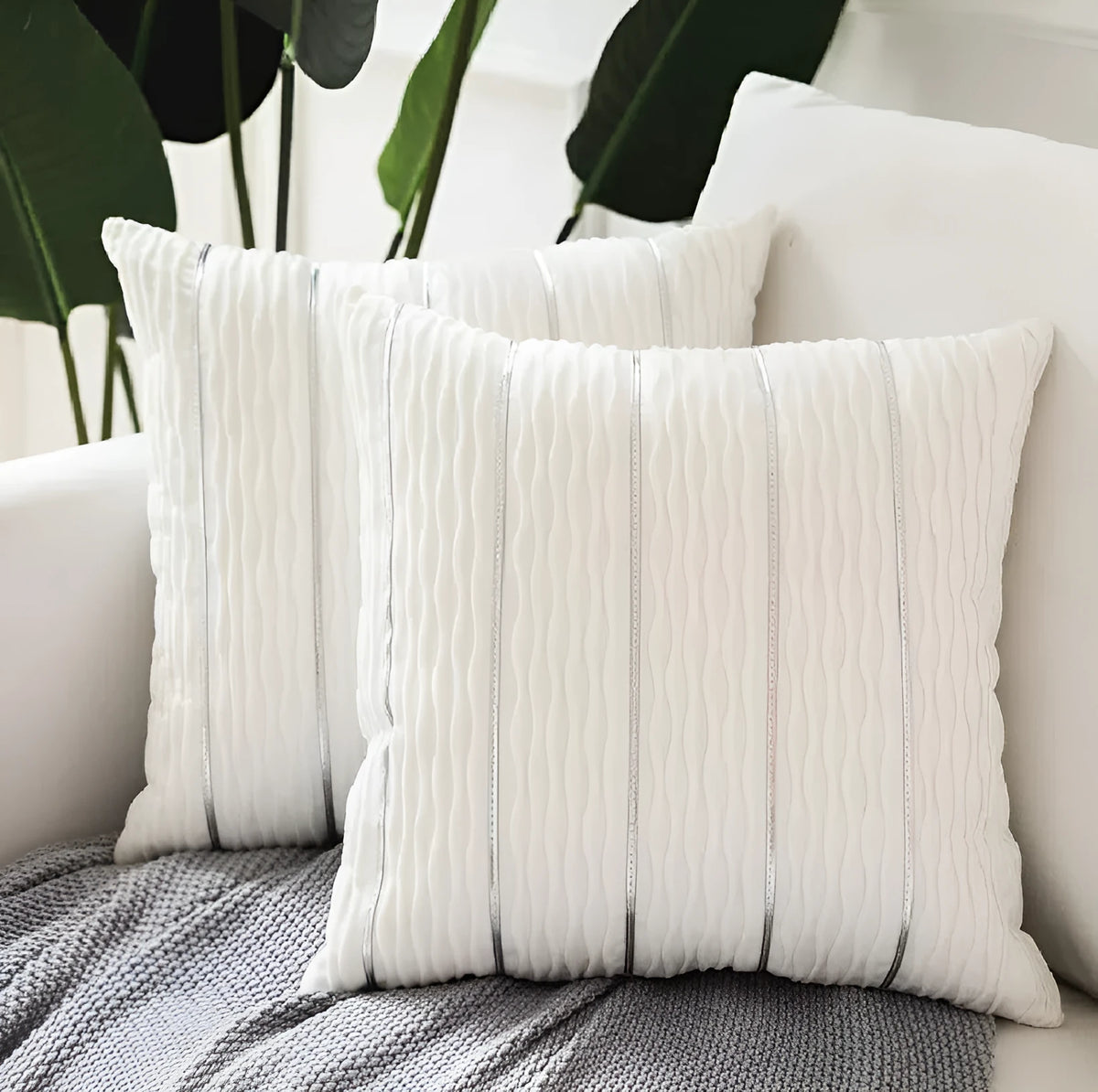 Square 45cm plush velvet pillow cover in wine red colour on a sofa.