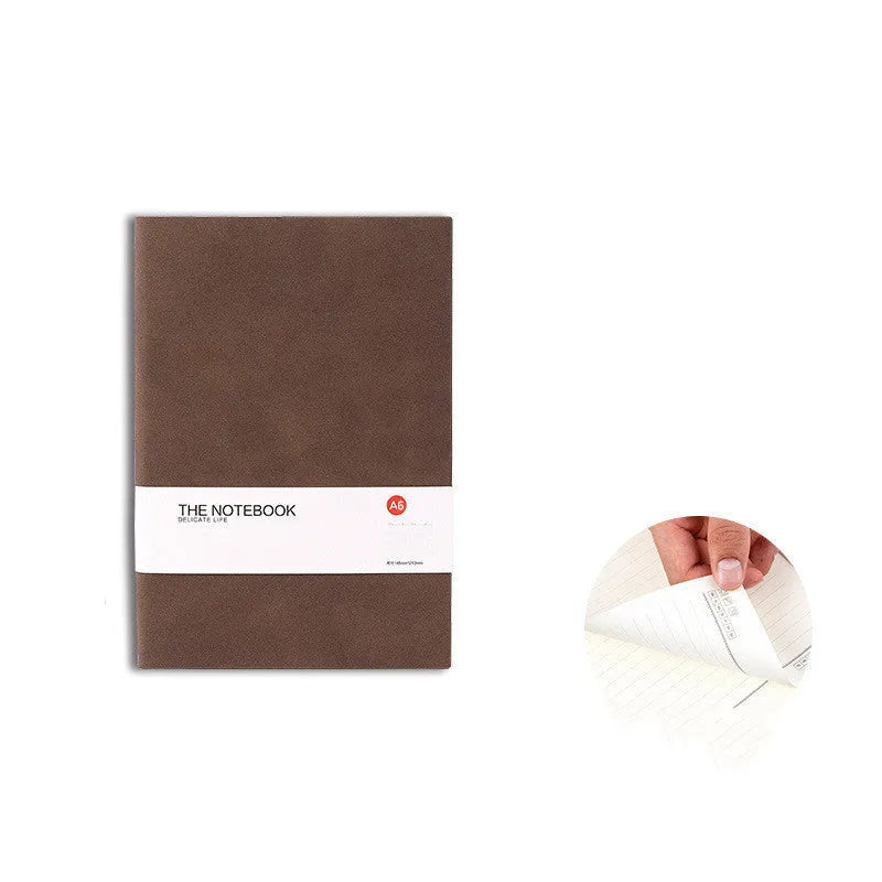 Simple solid colour A5 notebook with thickened pages open on a desk, showing lined paper.