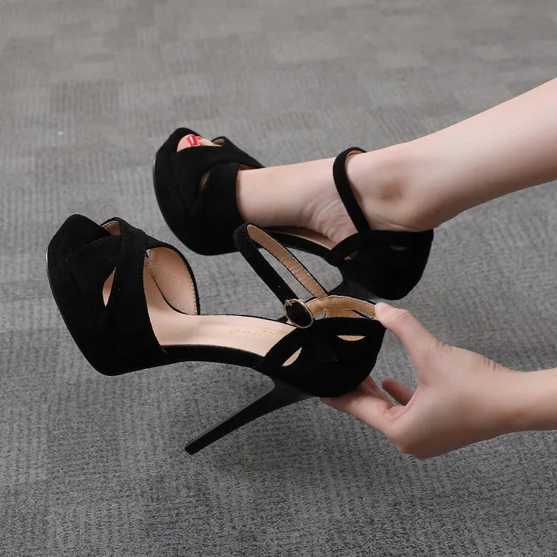 Black women's stiletto platform sandals with a fish mouth toe and Roman style design.