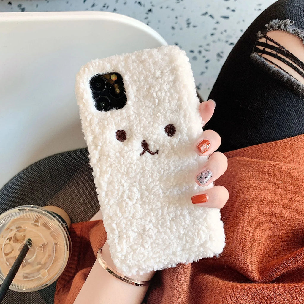 Brown embroidered plush cartoon bear face on a flexible TPU iPhone phone case.