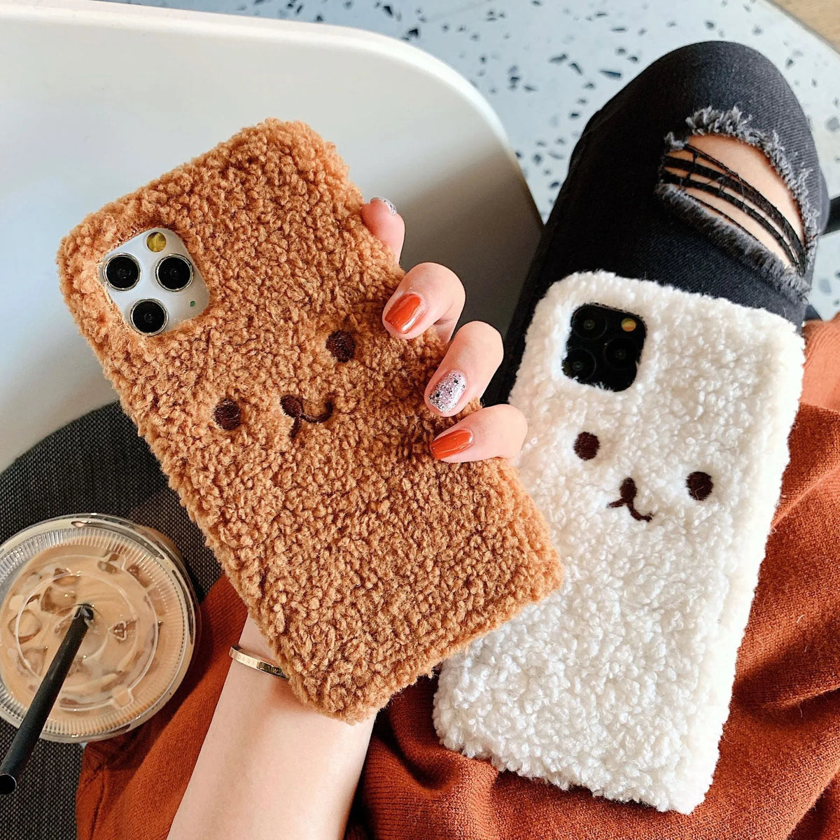 Brown embroidered plush cartoon bear face on a flexible TPU iPhone phone case.