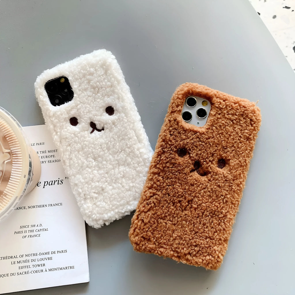 Brown embroidered plush cartoon bear face on a flexible TPU iPhone phone case.