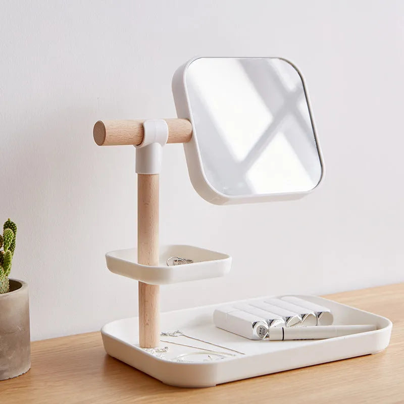 White desktop cosmetics storage box with mirror holding makeup brushes and lipsticks on a dressing table