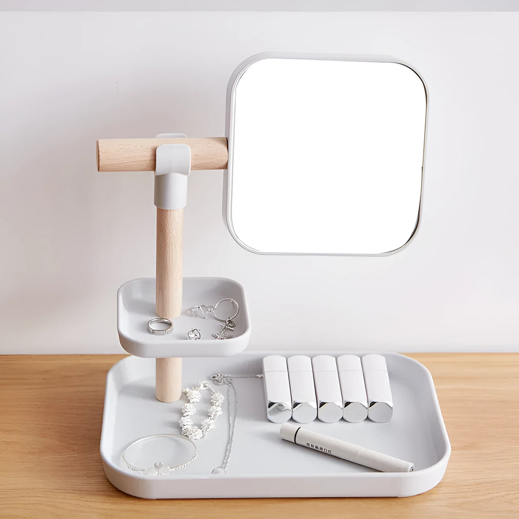 White desktop cosmetics storage box with mirror holding makeup brushes and lipsticks on a dressing table