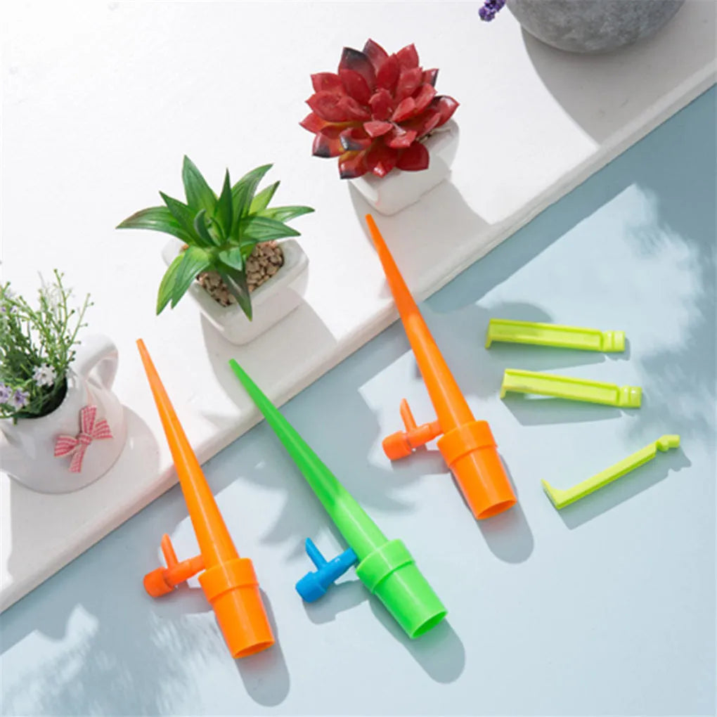 Set of 10 plastic plant watering spikes, 5 green and 5 orange, each 16.5cm x 3cm for garden pots.