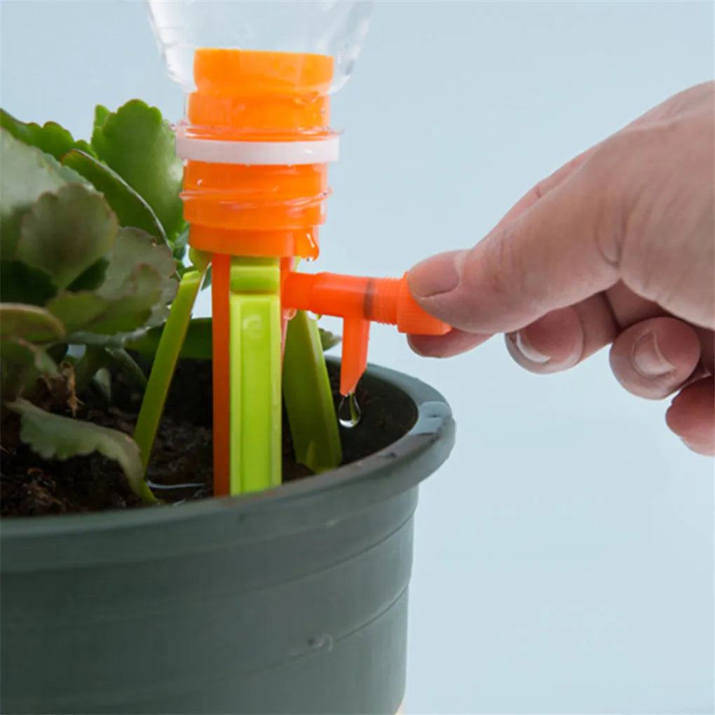 Set of 10 plastic plant watering spikes, 5 green and 5 orange, each 16.5cm x 3cm for garden pots.