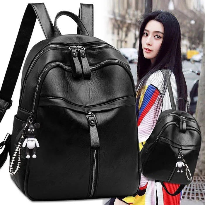 Medium black PU leather backpack with double straps showing internal organisation and waterproof features