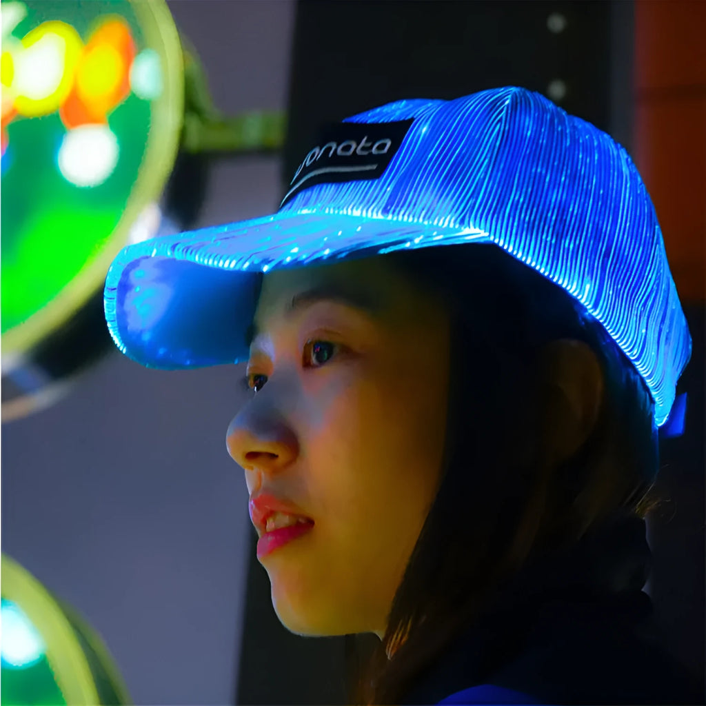 White fibre optic luminous baseball cap with LED glow on dark background