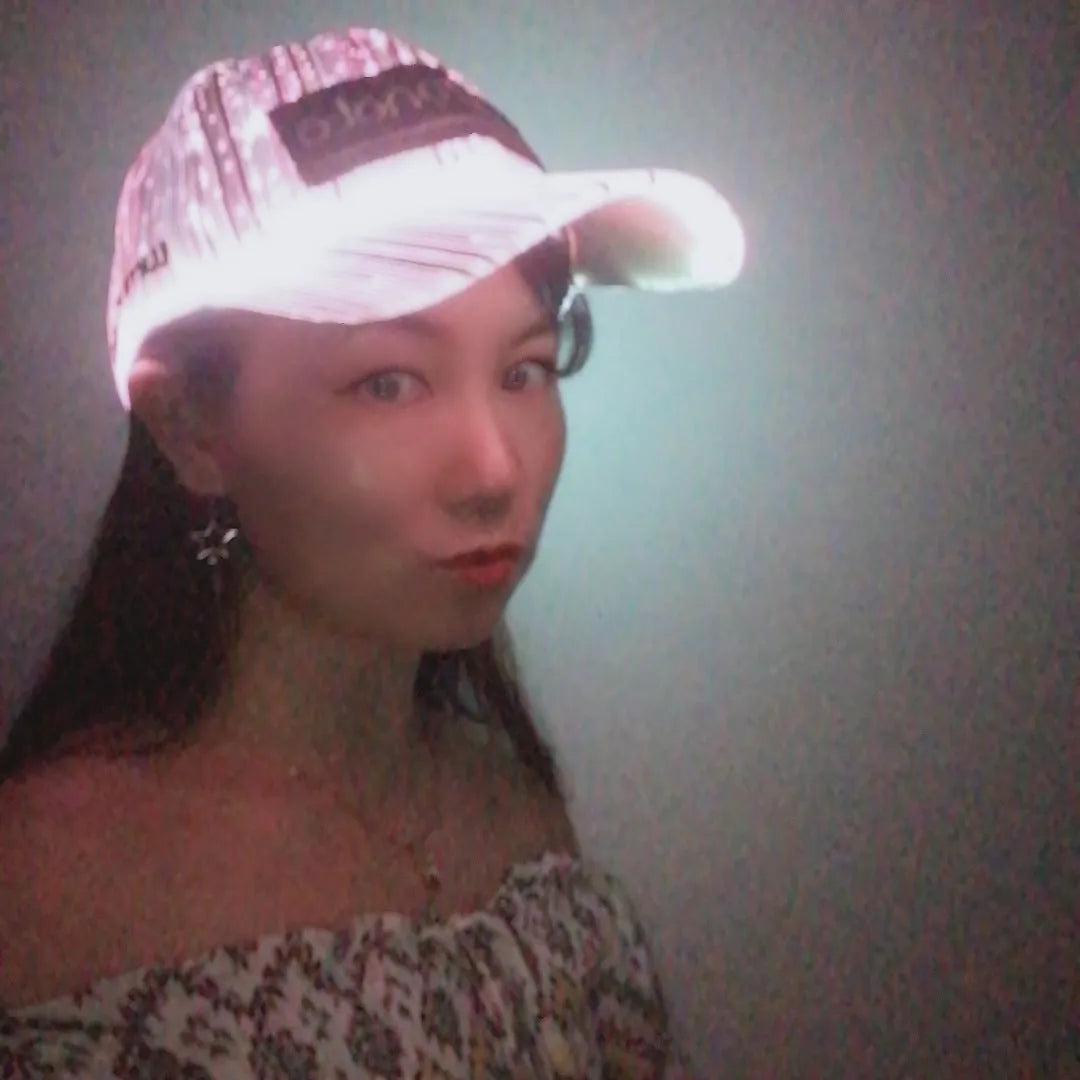 White fibre optic luminous baseball cap with LED glow on dark background