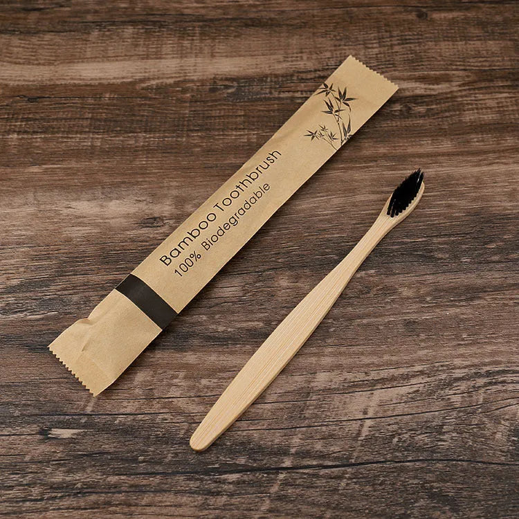 10 bamboo toothbrushes with coloured handles and charcoal bristles displayed together