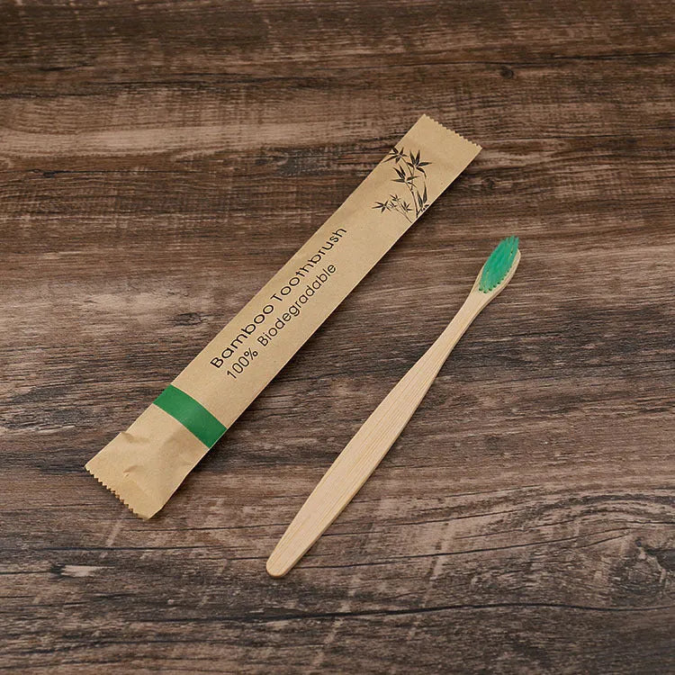 10 bamboo toothbrushes with coloured handles and charcoal bristles displayed together