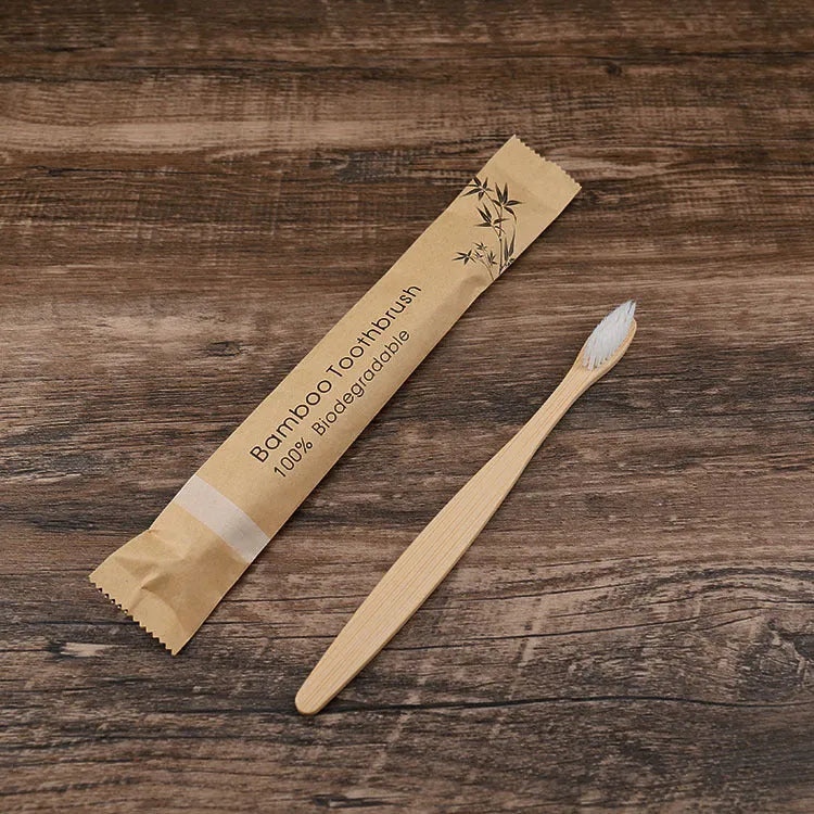 10 bamboo toothbrushes with coloured handles and charcoal bristles displayed together