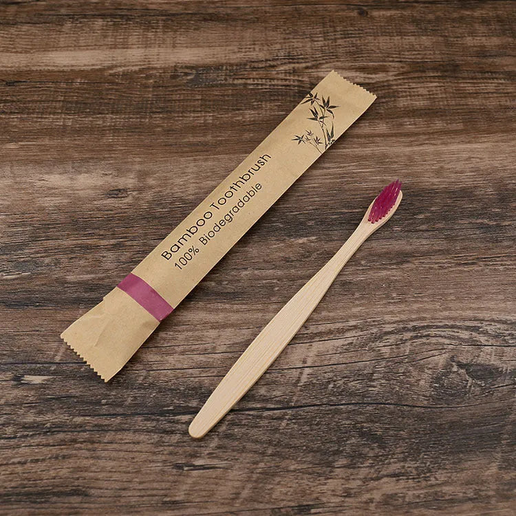 10 bamboo toothbrushes with coloured handles and charcoal bristles displayed together