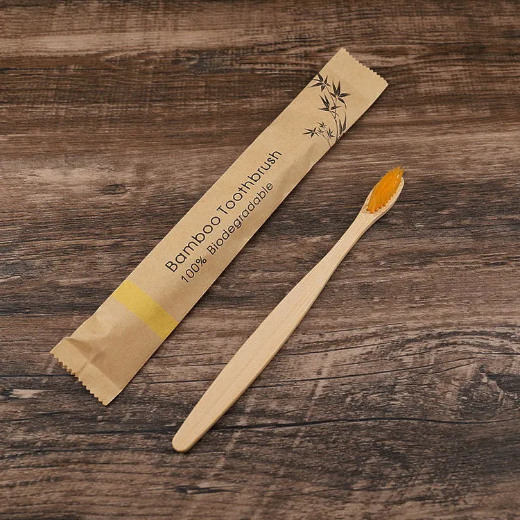 10 bamboo toothbrushes with coloured handles and charcoal bristles displayed together