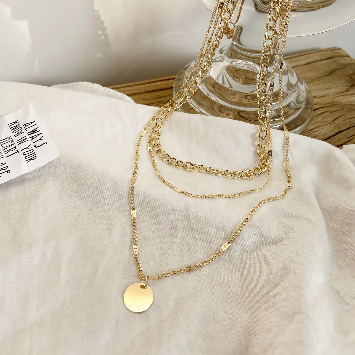 Women's multilayer necklace with disc pendant and clavicle chain in gold or silver electroplated alloy