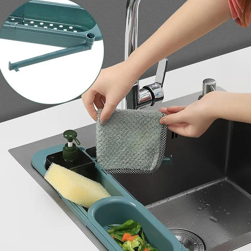 Adjustable telescopic kitchen sink rack organiser holding soap and sponge by drain