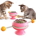 Rotating interactive cat toy with catnip balls in a clear top and a large suction cup base, in lake blue colour.