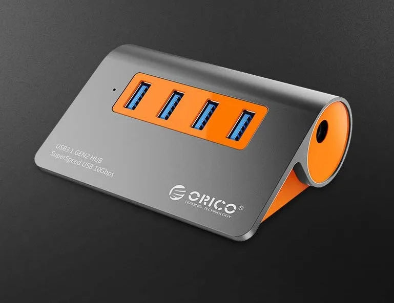 Dark grey and orange aluminium USB-C docking hub with four USB 3.1 ports and separate cable