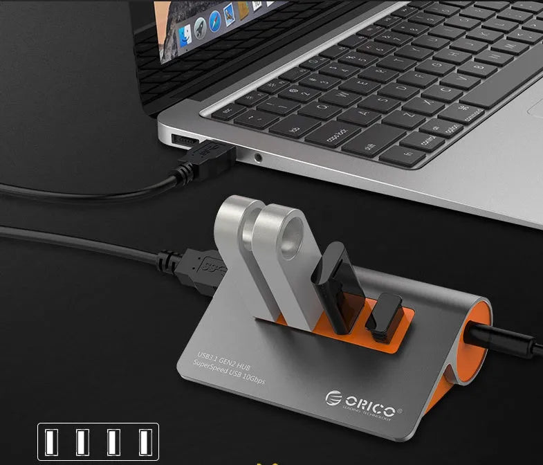 Dark grey and orange aluminium USB-C docking hub with four USB 3.1 ports and separate cable