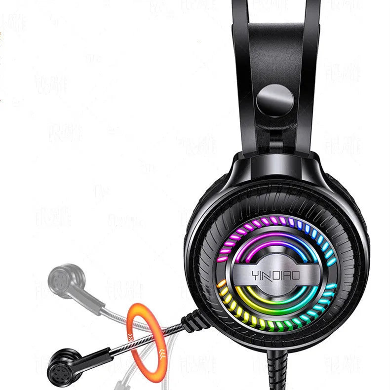Black and white wired over-ear PC gaming headset with microphone on a desk.