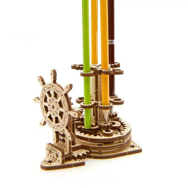 Ukrainian wooden rotating pen holder model with visible gears on a desk.