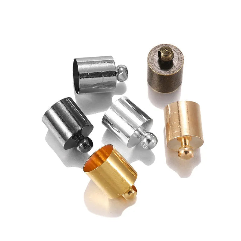 Assortment of small copper jewellery caps in different colours and sizes on a white background.