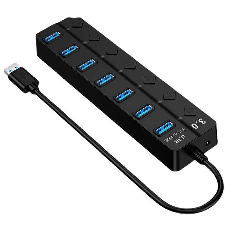 Black 7-port USB 3.0 hub with external power supply unit on a desk