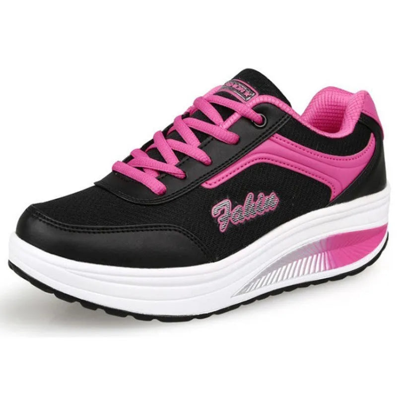 Women's heelless sports travel shoes in a grey colour with a middle heel, shown on a light background.
