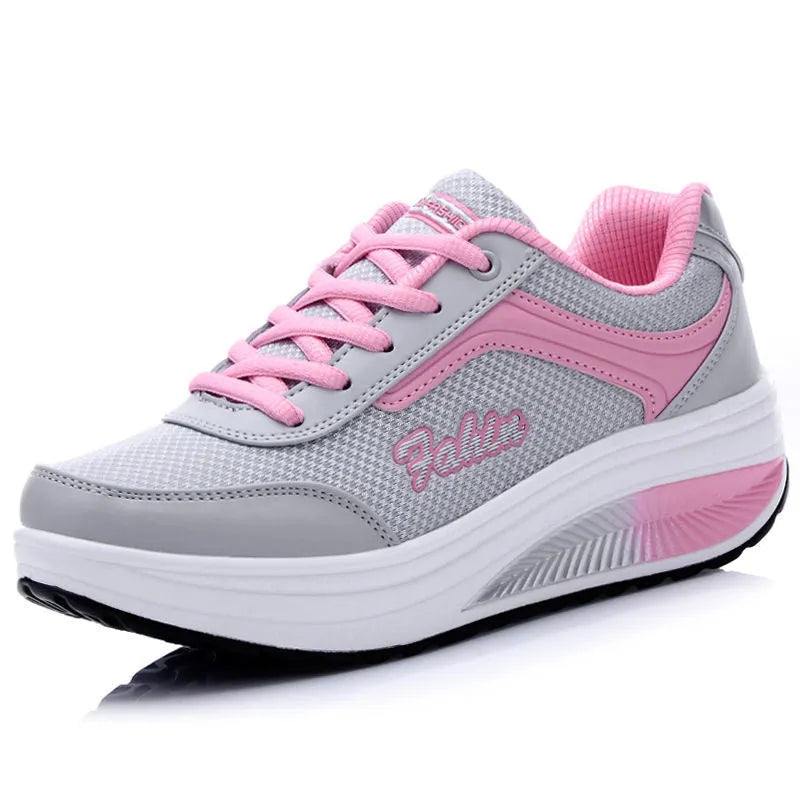 Women's heelless sports travel shoes in a grey colour with a middle heel, shown on a light background.