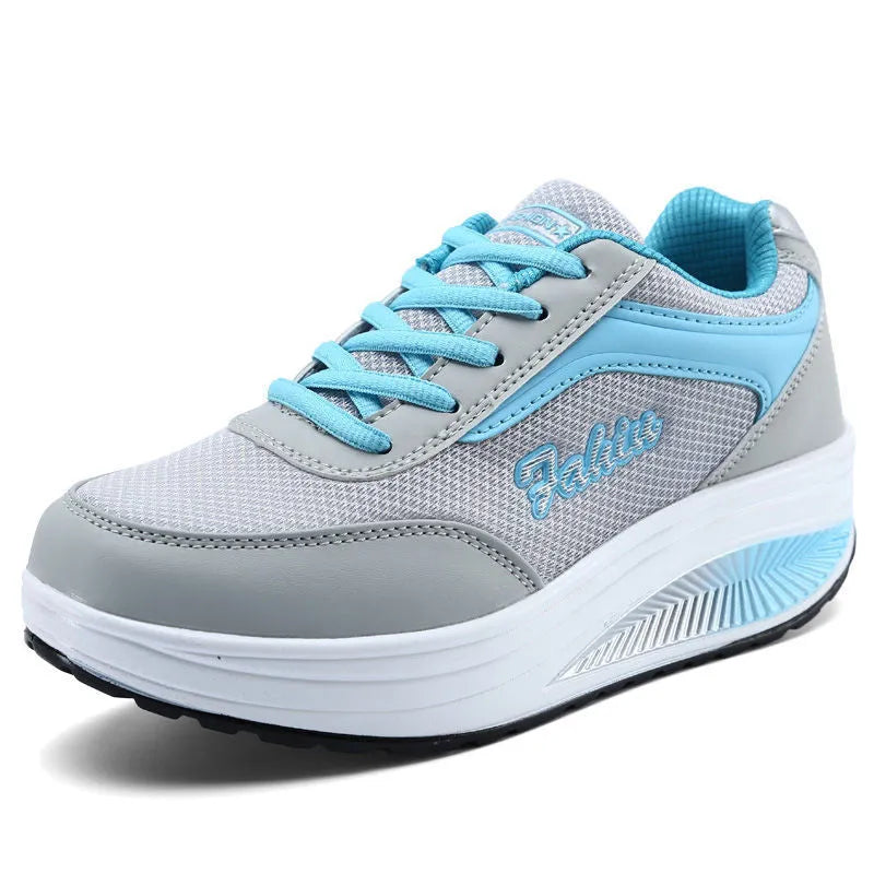 Women's heelless sports travel shoes in a grey colour with a middle heel, shown on a light background.