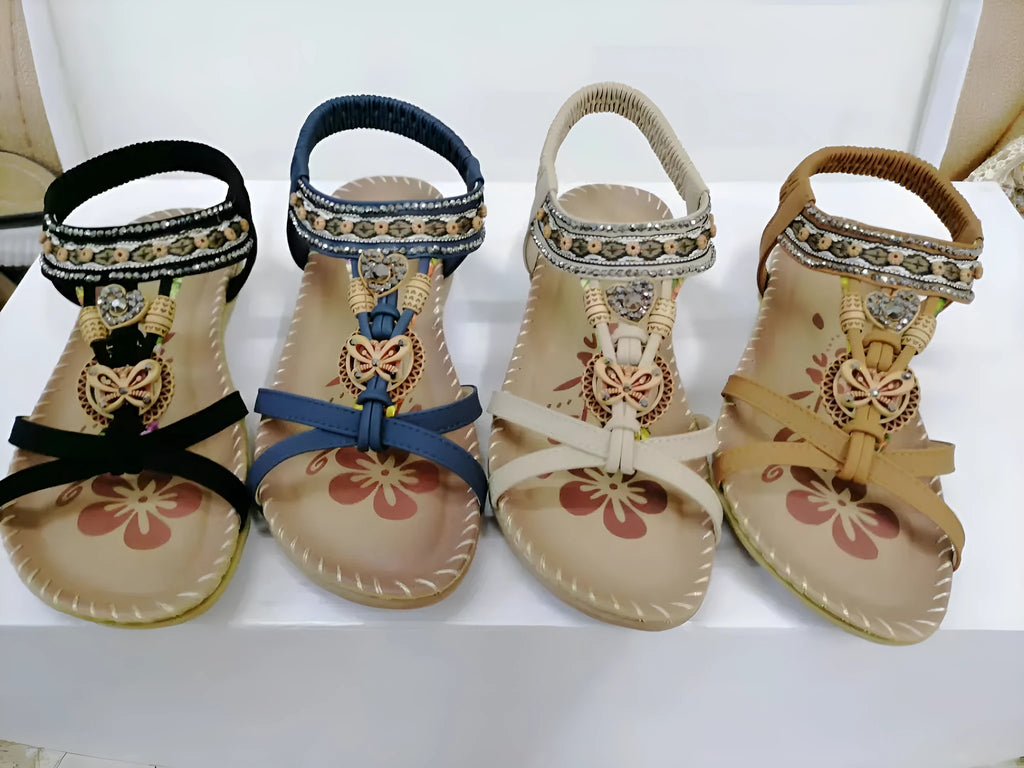Large size flat sandals with flower and rhinestone detail, PU upper, round toe, and raw rubber sole in black, royal blue, apricot, or brown.