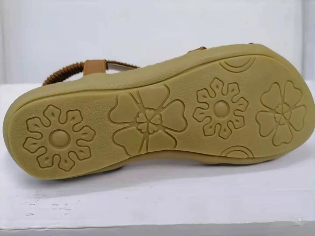 Large size flat sandals with flower and rhinestone detail, PU upper, round toe, and raw rubber sole in black, royal blue, apricot, or brown.