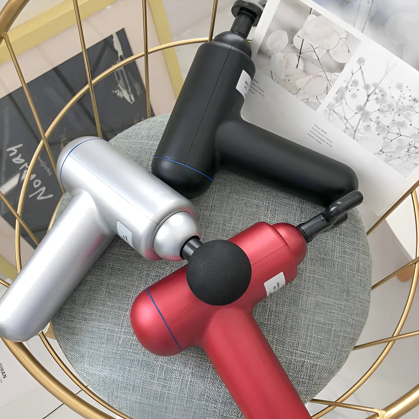 Cordless fascia massage gun with USB charging port in grey, red, or black colour options