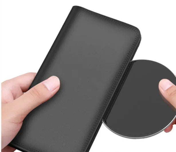 Ultra-thin aluminium wireless charging pad in silver on a wooden table